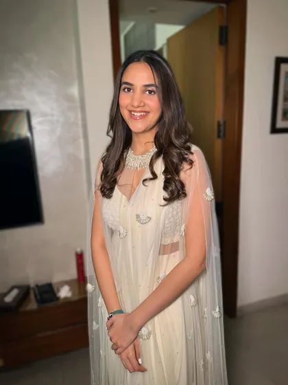 Her smile says it all. The makeup is minimal and fresh, letting her natural happiness be the focus.