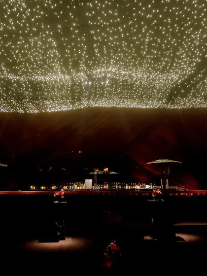 The stage is the focal point for performances. We designed this one with a ceiling of thousands of fairy lights, which can be programmed to create different effects, from a starry night sky to a high-energy light show.