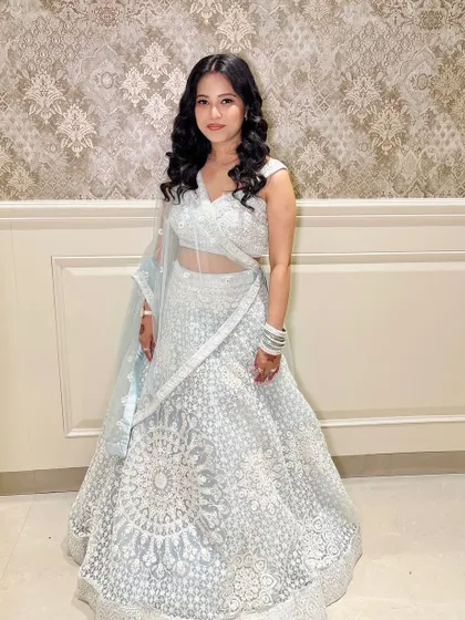 A full-length shot of the client in her elegant lehenga.