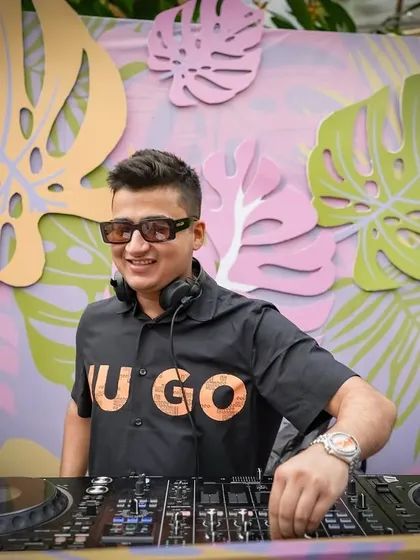 All smiles from behind the decks at this fun and colorful poolside event. The decor was as vibrant as the playlist.