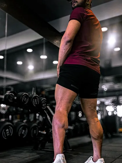 A member proudly showcasing the results of a tough leg day. This image is a testament to the hard work and dedication that our members put in to build strength and definition.