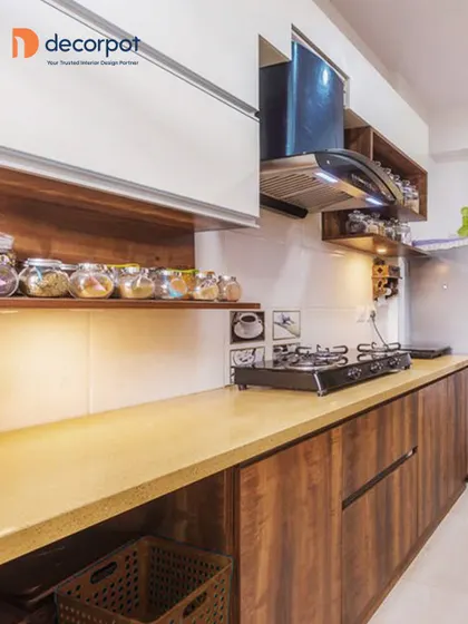 A close-up of a kitchen that blends natural wood textures with clean white cabinets. The open shelving is perfect for storing everyday spices, while the under-cabinet lighting provides excellent task illumination.