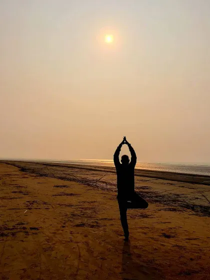 This is Vrikshasana, the Tree Pose, practiced at sunrise. This asana helps us find balance and stability, rooting down into the earth just like a tree. It reminds us that even with the world moving around us, we can find a steady center.