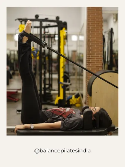 Legs in straps, working on hamstring flexibility and core control. This move feels as good as it looks.
