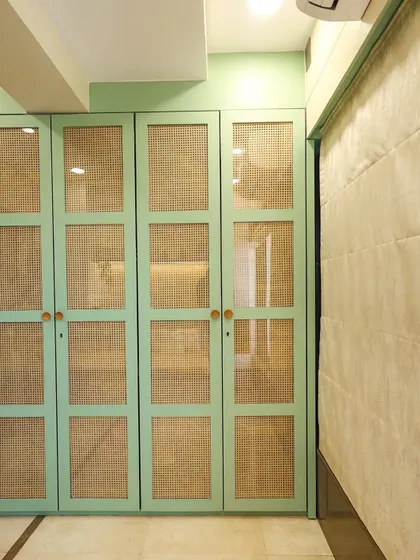 A close-up of the board-and-batten style wardrobe doors in a beautiful Dutch green, showcasing our love for unique color combinations.
