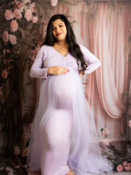 A confident standing portrait in a beautiful lavender gown. The pose is simple yet powerful, celebrating the mother-to-be.