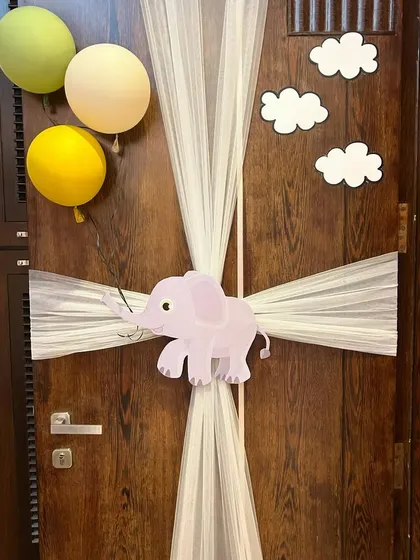 A simple yet adorable zoo-themed door decoration to welcome home a new baby boy, featuring a cute elephant and soft tulle.