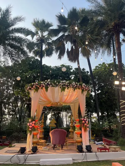 A lovely pastel-themed mandap perfect for a daytime garden wedding. The soft peach drapes and floral arrangements create a light and airy feel, ideal for an intimate ceremony.