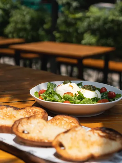 Our classic burrata and tomato salad, served with slices of toasted sourdough. It's a simple, perfect starter to share, especially in our sunny outdoor seating.