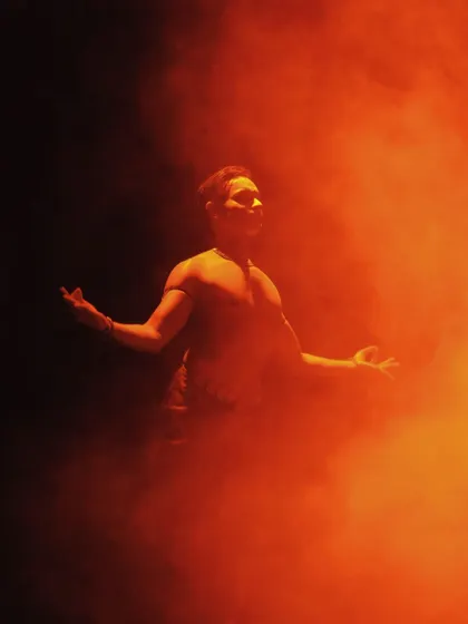 An ethereal shot from 'ATAH', where I am enveloped in orange smoke. This visual effect adds a layer of mystique and drama to the performance.