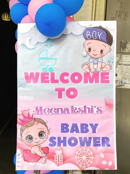 A custom welcome board for Meenakshi's baby shower, with cute "boy or girl" graphics.