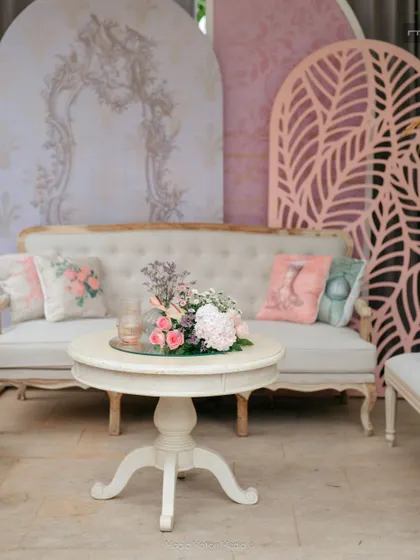A lounge area with classic furniture set against a backdrop of printed and laser-cut panels.