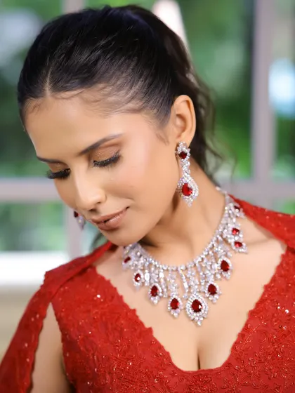Another beautiful shot of the red cocktail look, highlighting the glossy nude lips and the way the makeup enhances her natural features.