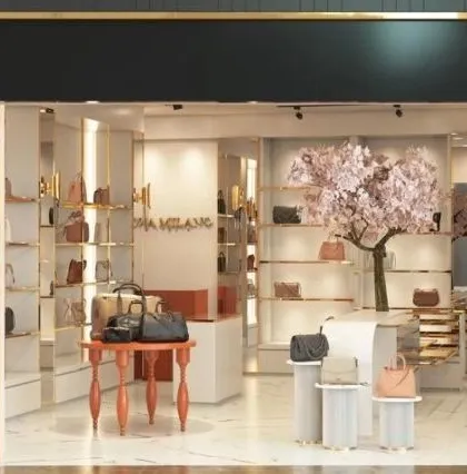 A design concept for a Da Milano store interior, featuring elegant display tables and a decorative cherry blossom tree to create a unique and feminine ambiance.