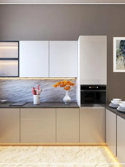 A kitchen design option for a project in Sonipat, Haryana. It combines beige and white cabinets, a dark countertop, and a marble-patterned backsplash, with backlit glass cabinets for display.