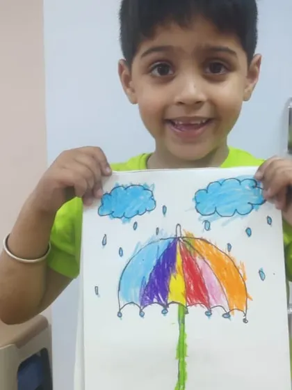 This colorful umbrella in the rain is a perfect example of imaginative drawing. The student has done a wonderful job blending colors to create a rainbow effect.