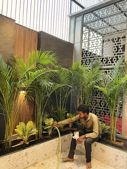 Postcards from a busy April. Here's my team member watering a newly planted indoor garden bed. We always make sure every plant is settled in properly.