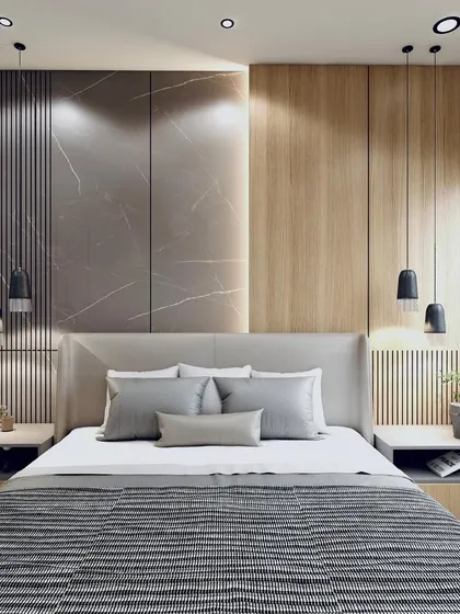 Discover the perfect blend of style and comfort. This bedroom design uses a mix of fluted wood panels and marble-textured walls, with elegant pendant lights flanking the bed for a modern, hotel-like feel.