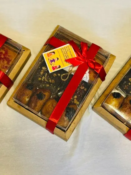 Here are multiple budget-friendly Rakhi hampers, all packed and ready for gifting. Each box contains a delicious assortment of my homemade baked goods, tied with a festive red ribbon.