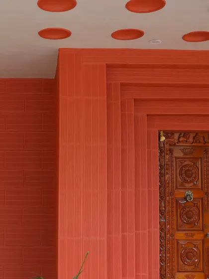 A wider view of the entrance detail, highlighting the rich color and texture of the materials.