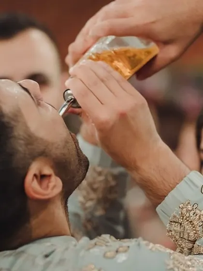 The groom taking a celebratory shot with his friends. It's a moment of fun and camaraderie that's an essential part of any great wedding party.