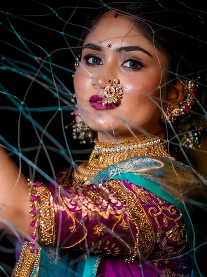 This creative shot for Narali Purnima captures the essence of the Koli tradition. The makeup features a bold lip and defined eyes, creating a striking look that honors the festival of the sea.