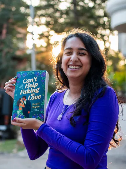 A huge smile for my second book baby, "Can't Help Faking in Love." It's a story about a woman with Bollywood roots who hires a barista as her fake boyfriend.