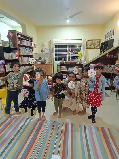 A duplicate of the group photo with their dot paintings.