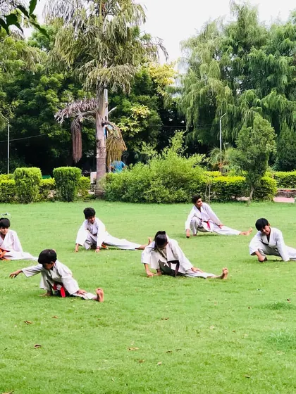 Another angle of our stretching routine. We ensure every student warms up and cools down properly to maintain their physical health.