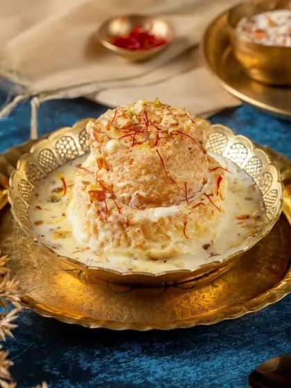 Our Shahi Balai Tukda is a dessert fit for royalty. Layers of cream-soaked bread are delicately fried and drenched in a saffron-infused syrup, creating a masterpiece of Mughal indulgence.