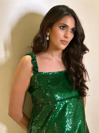 A closer look at the Ganni sequin dress. The ruffled straps add a playful touch to this glamorous look.