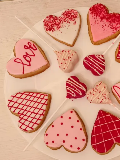 My Valentine's collection also includes these beautifully decorated heart-shaped cookies and cake pops. They come in various pink, red, and white designs, perfect for a sweet gift platter.