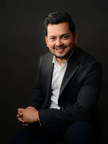 A seated portrait that feels both relaxed and professional. This is a great way to conclude a series of headshots, showing a calm and confident demeanor.