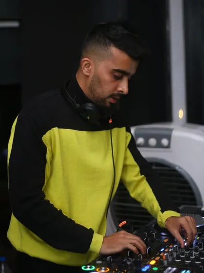 In the zone at the DJ booth, carefully selecting the next track. The art of DJing is in the transitions and the journey.