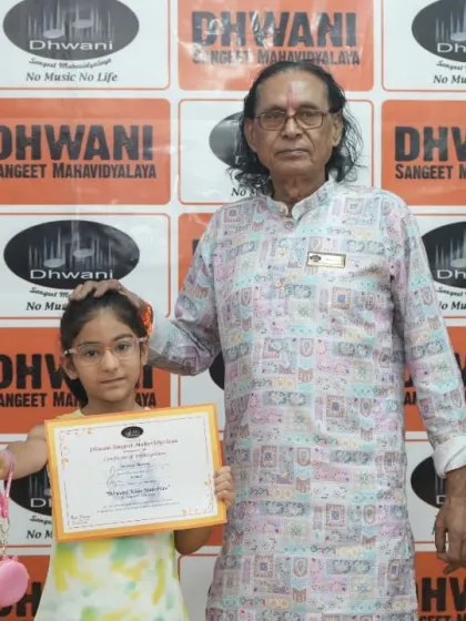 A senior guru with his young student, a moment of pride and blessing.