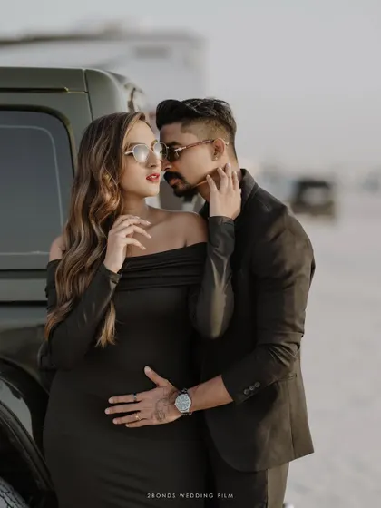 An intimate and stylish pose by a vehicle, where the groom's hand rests gently on the bride's waist, showcasing their connection and modern aesthetic.