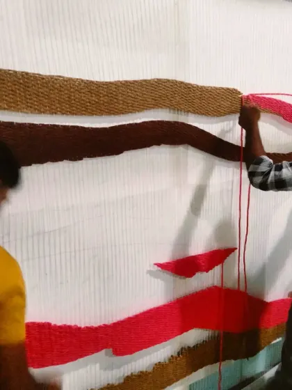 Teamwork makes the dream work. Two of my artists collaborating on the large tapestry frame.