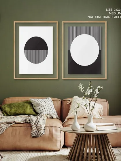This minimalist set of two prints explores the duality of sun and moon through geometric abstraction. The clean lines and black-and-white palette, shown here in natural transparent frames, are ideal for a modern, Scandinavian-inspired interior.