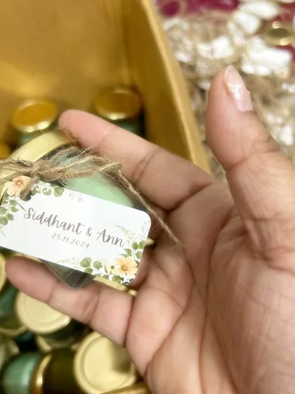 A close-up of the custom tag for Siddhant & Ann's wedding favors, tied with a rustic jute string. I can customize tags with names, dates, and thank you messages.