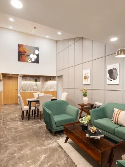 We designed this open-concept suite to feel spacious and airy. The high ceilings and cohesive design connect the living area to a compact dining space, creating a functional and unified interior for guests.