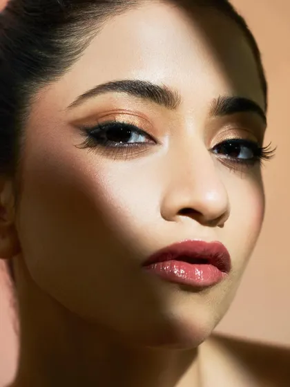 A close-up on the eye, showing the clean lines and the beautiful contrast between the dark liner and the warm eyeshadow.