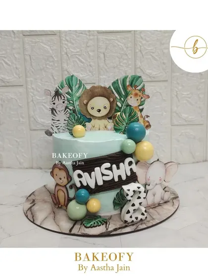 This is my current favorite: the cutest jungle theme cake. It's decorated with adorable animal toppers like a lion, zebra, and elephant, surrounded by tropical leaves.
