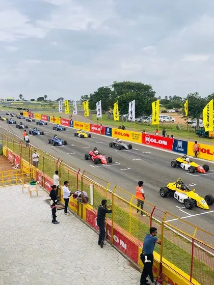 A wide view of the starting grid from the stands, showing the scale of the JK Tyre Formula LGB Championship.