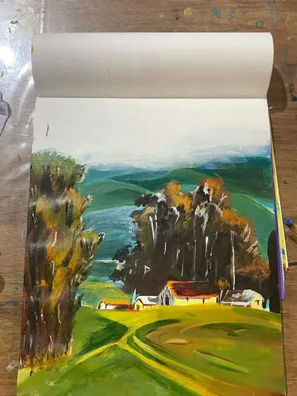 A closer look at a landscape study in an artist's sketchbook. Practice is key, and I encourage students to experiment with techniques before starting on a final canvas.