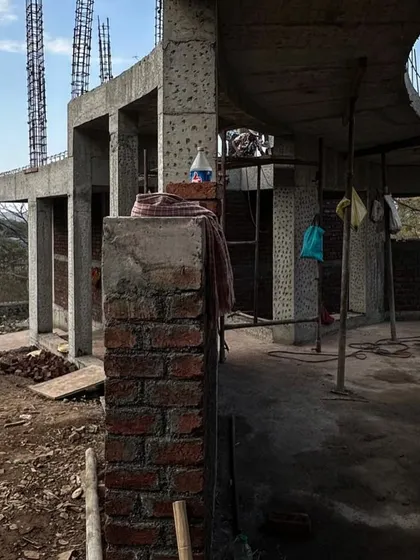 The raw concrete and brick structure of an Alibaug house. This behind-the-scenes view shows the bones of the building before the finishing materials are applied.