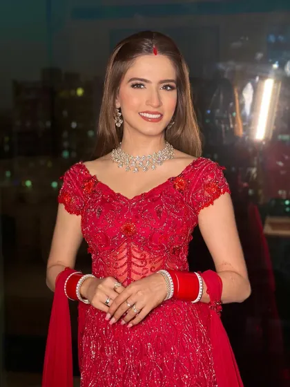 A happy, smiling bride ready for her reception party. The makeup is glamorous yet feels light, allowing her to feel comfortable and beautiful.
