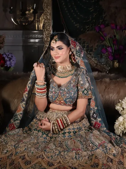 This shot highlights the side profile and the intricate details of the bridal jewelry and dupatta.