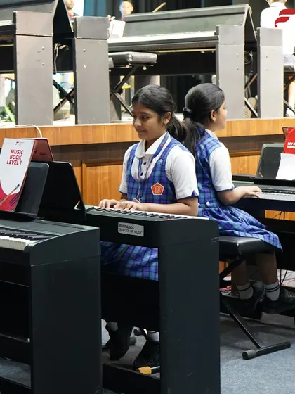 Two students play a duet on their keyboards during the Pune recital. Paired and group performances are a key part of our teaching method, fostering collaboration and listening skills.