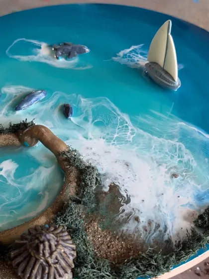 This perspective highlights the 3D elements of the ocean artwork, including the textured island and realistic white waves.