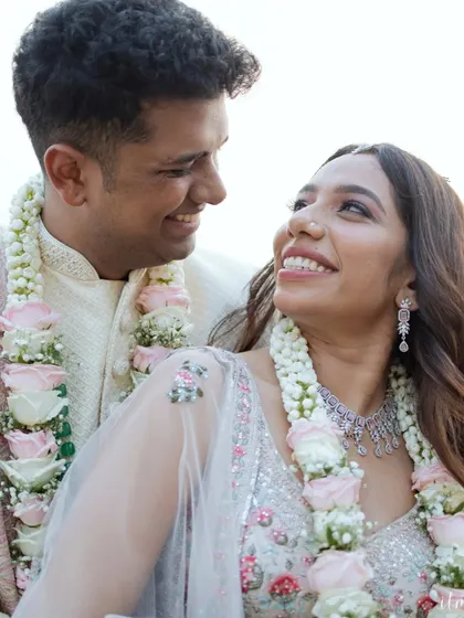 A beautiful portrait capturing the loving gaze between the newly married couple. Adorned with their varmalas, their smiles radiate happiness and contentment.
